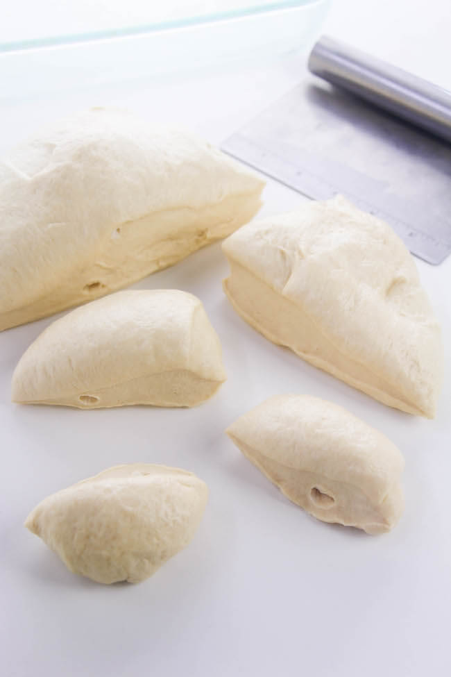 cutting bread dough into smaller pieces