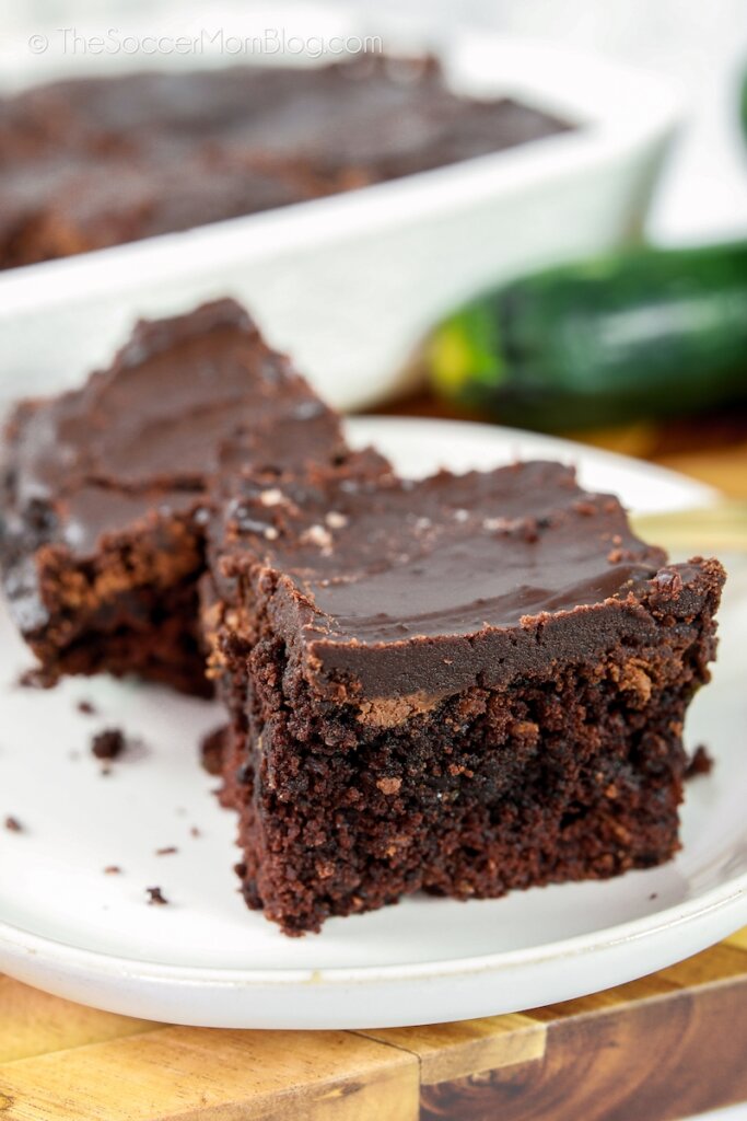 plate of chocolate zucchini brownies with chocolate icing