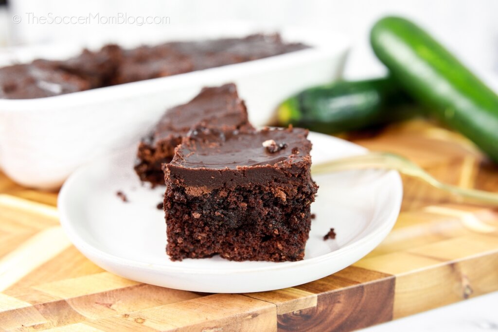 plate of chocolate brownies with zucchini on cutting board