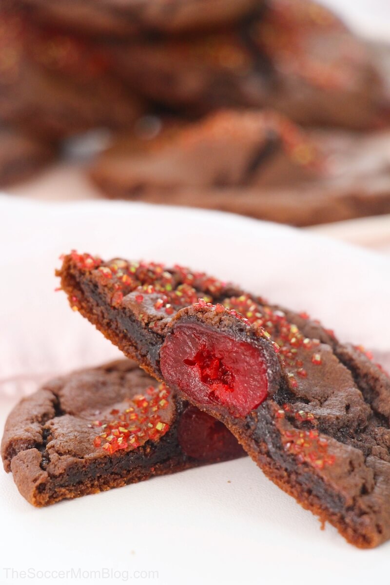 chocolate covered cherry cookies cut in half to show cherry inside