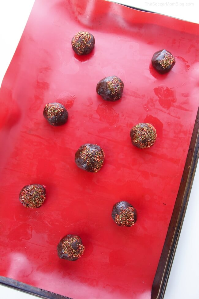 chocolate cherry cookie dough balls on baking sheet