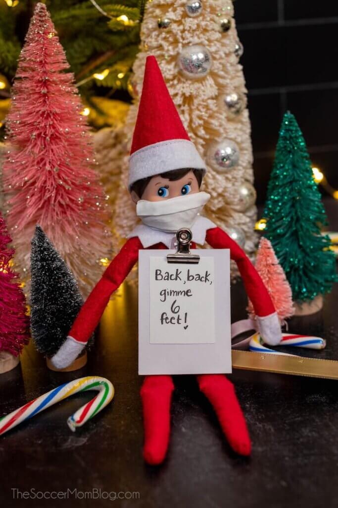 Elf on the Shelf with clipboard and ruler "gimme 6 feet"