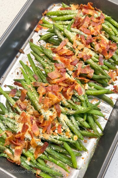 top-down view of a pan of roasted green beans with bacon.