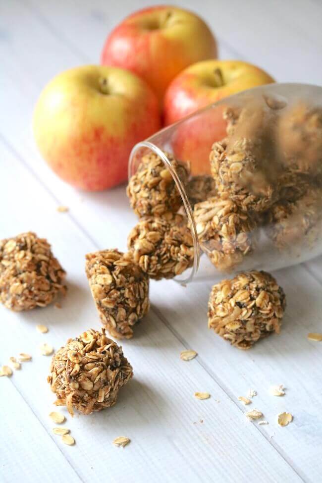 granola balls with apples in background