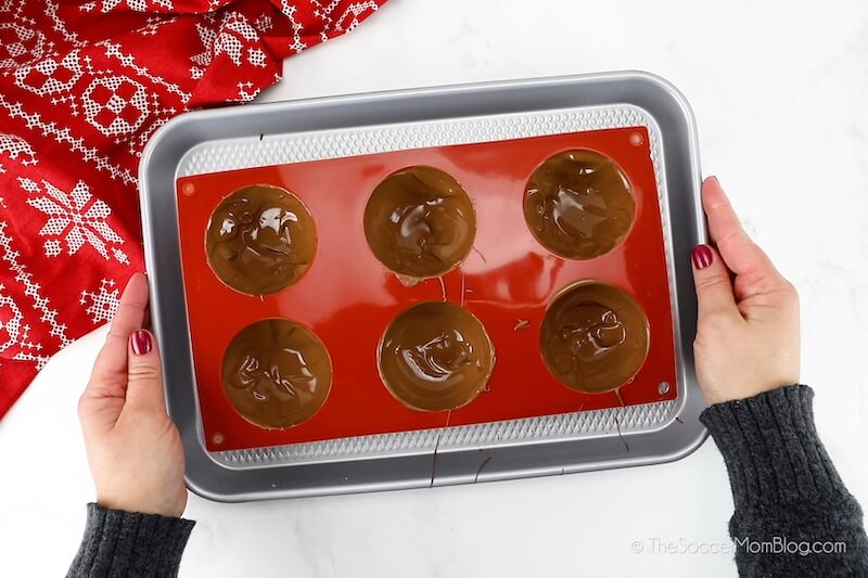 filling hot cocoa bomb molds with melted chocolate