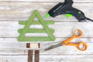 making a Christmas tree ornament with popsicle sticks