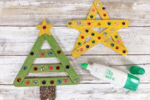 decorating popsicle stick Christmas ornaments with rhinestones