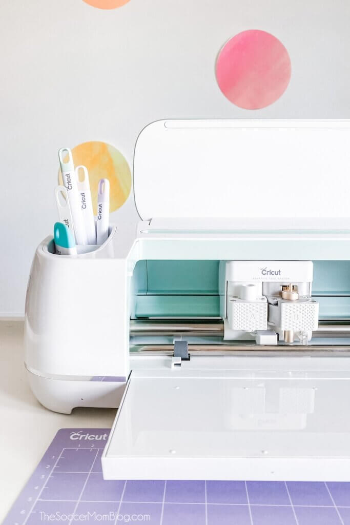 Cricut Maker machine and tools in front of a polka dot wall