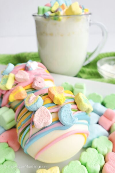 white chocolate hot cocoa bombs decorated with Lucky Charms marshmallows