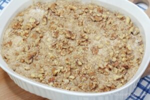 walnut crumble on top of cake batter in baking dish