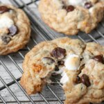 chocolate chip cookie torn open with gooey marshmallows inside