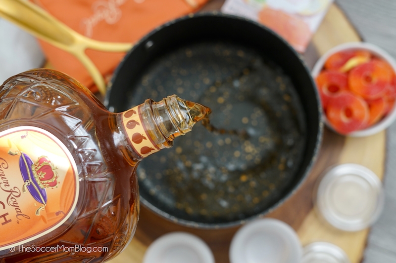 pouring Crown Royal Peach into saucepan