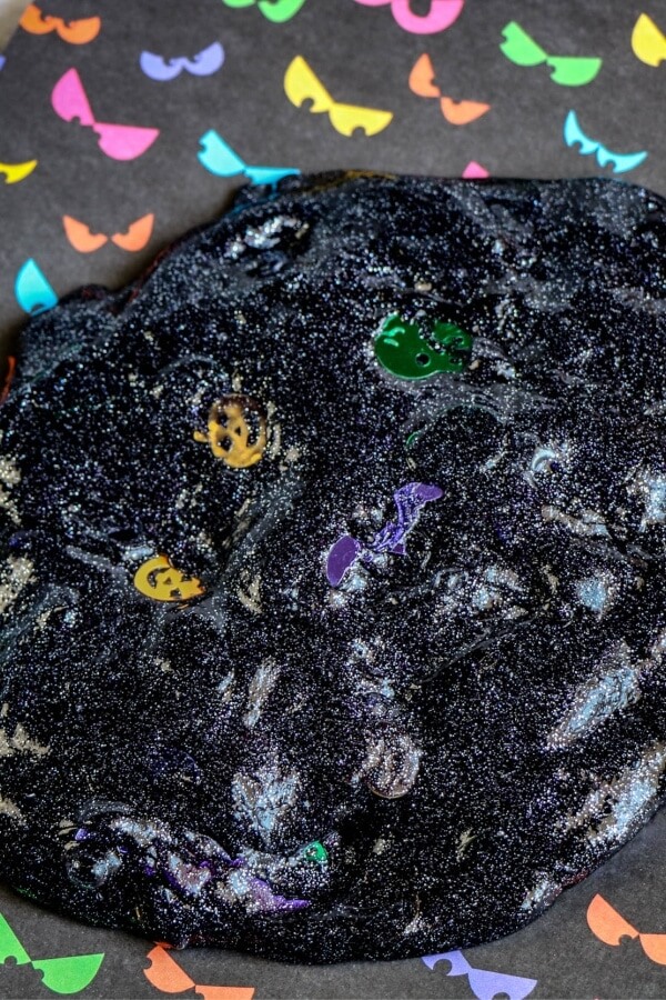 black glitter slime with pumpkin confetti