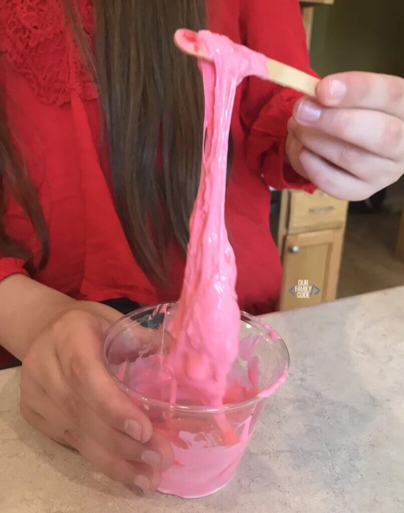 child playing with pink slime