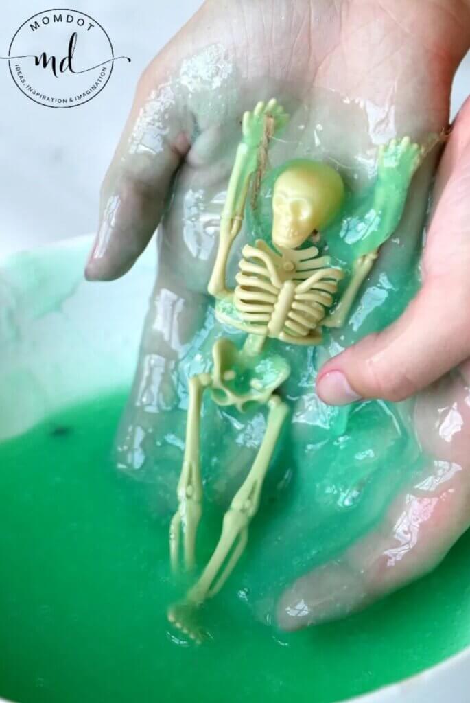 green slime with toy skeleton