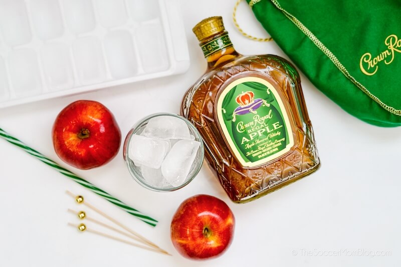 glass filled with ice and a bottle of Crown Royal Apple whisky