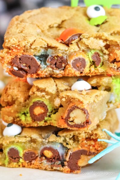 stack of Halloween monster cookie bars with candy and eyes