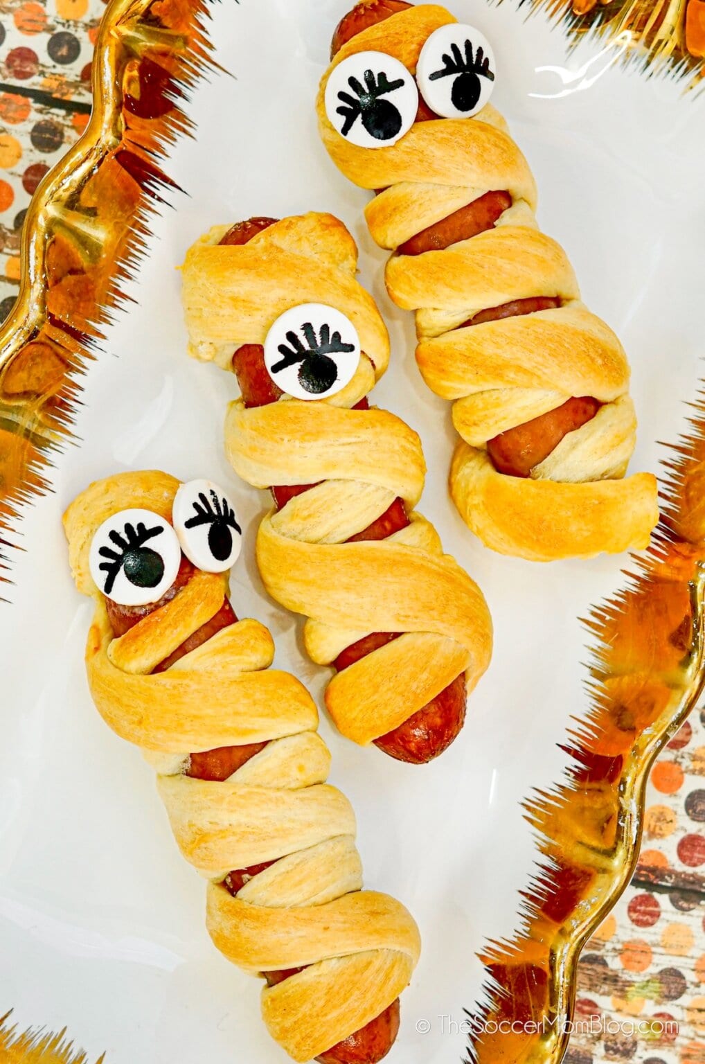 hot dog mummies crescent roll dough wrapped with olive eyes golden baked Halloween kids family dinner