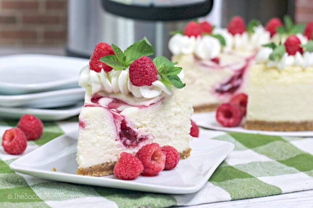 Slices of Instant Pot Raspberry Cheesecake on a table