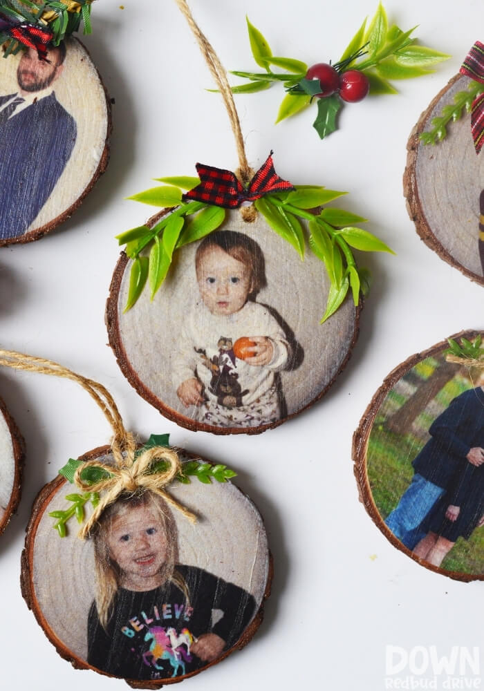 wood slice ornaments with family photos on them