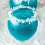 icy blue Jack Frost Cocktail with snowy coconut rim