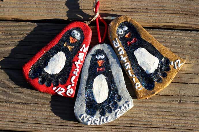 salt dough ornaments with child's footprint painted like penguins