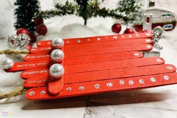 painted popsicle stick sled ornament