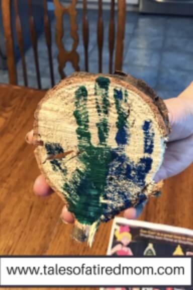 wood slice with child's handprint