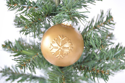 gold ornament with embossed snowflake