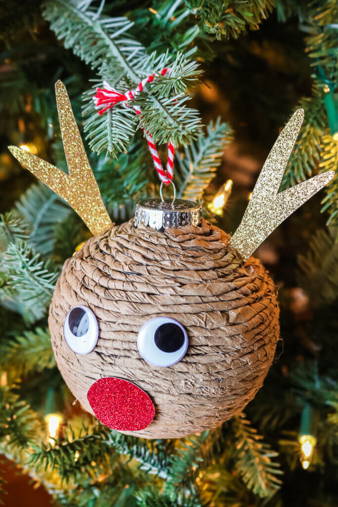round ornament covered in twine with reindeer face decorations