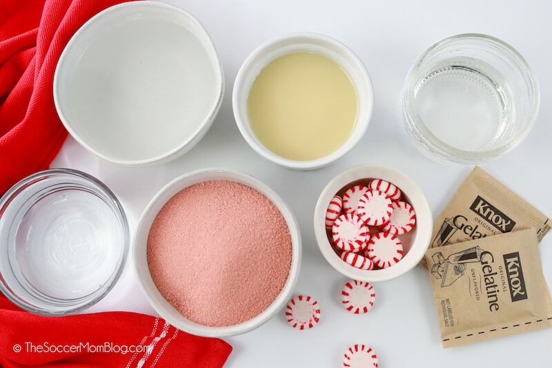 ingredients needed to make candy cane jello shots, in bowls on counter