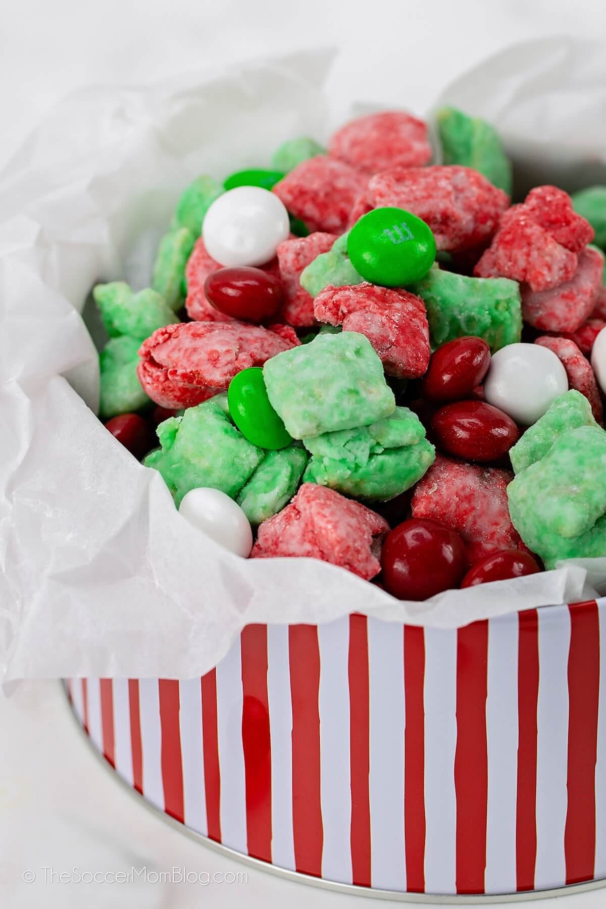 red and green Christmas snack mix in holiday tin