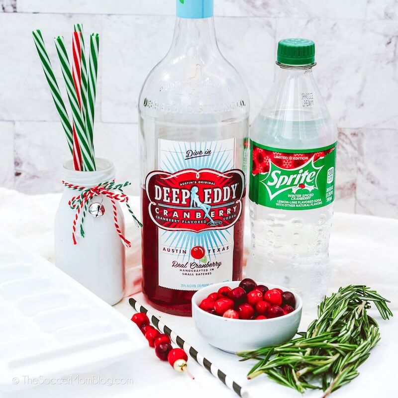 bottle of Cranberry vodka, Sprite, and a bowl of fresh cranberries