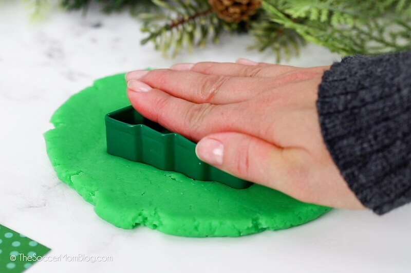 cutting our a Christmas tree cookie from playdough