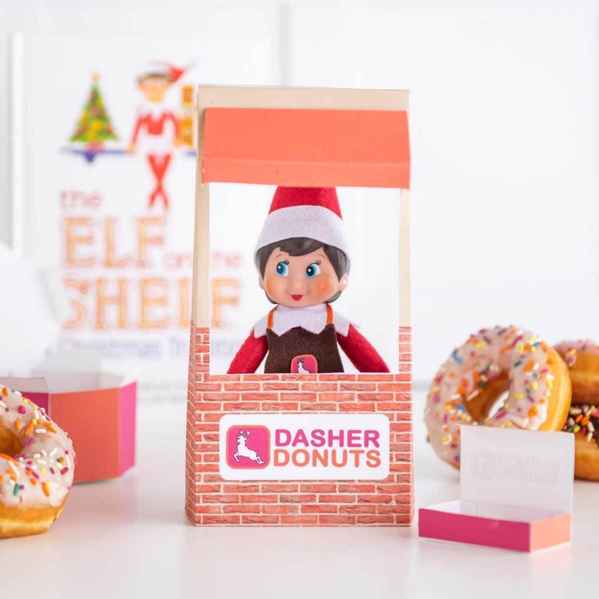 Elf sitting in a homemade donut stand.