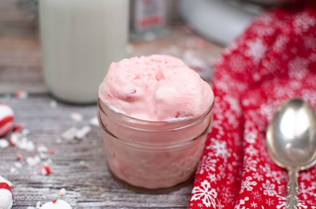 homemade candy cane ice cream with jar of milk and mints on counter