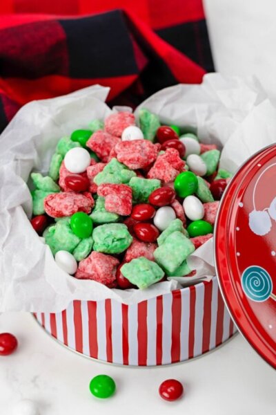 holiday tin filled with homemade Christmas Puppy Chow, red and green snack mix