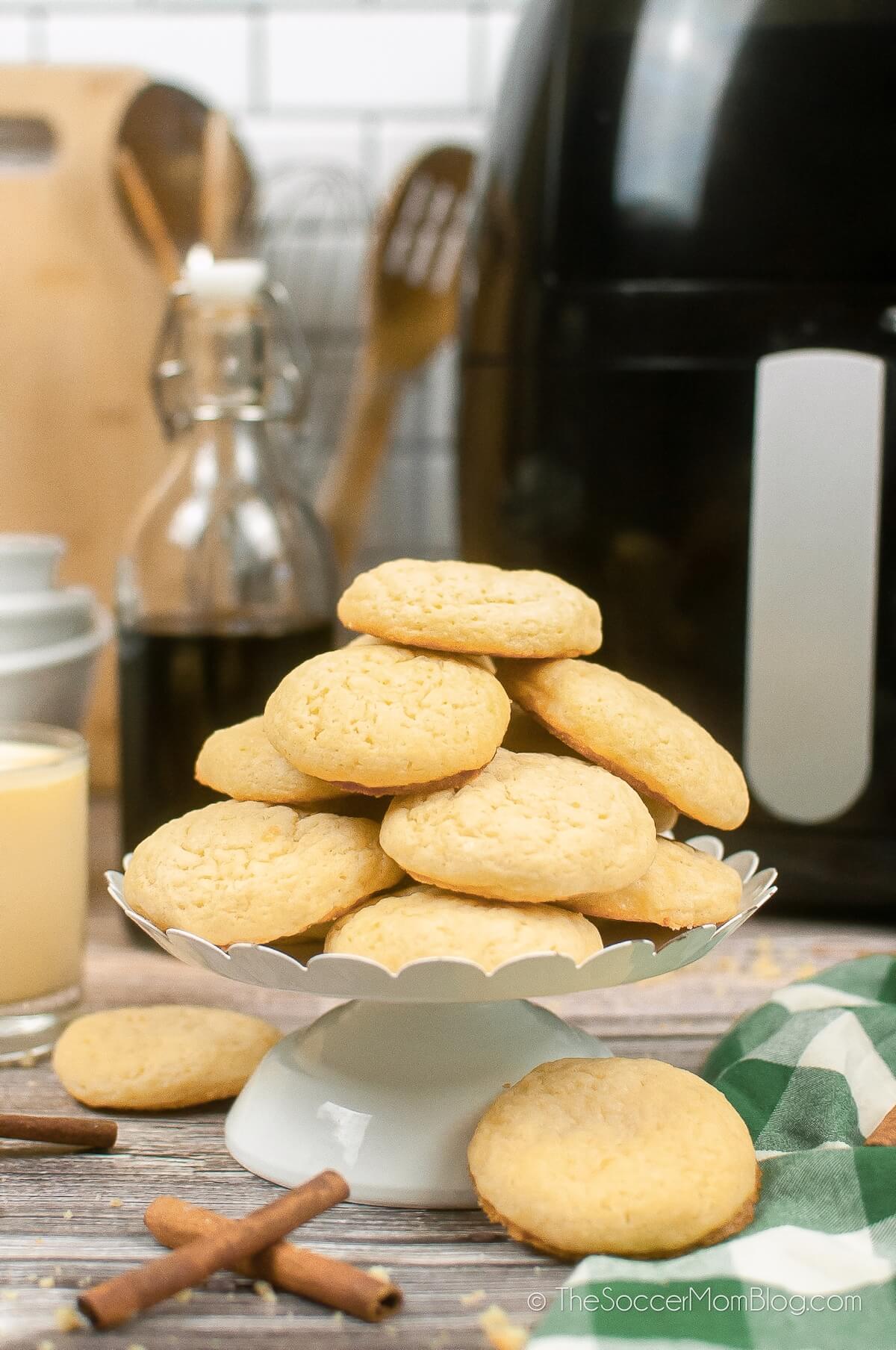 plate of air fryer eggnog cookies with supplies in background
