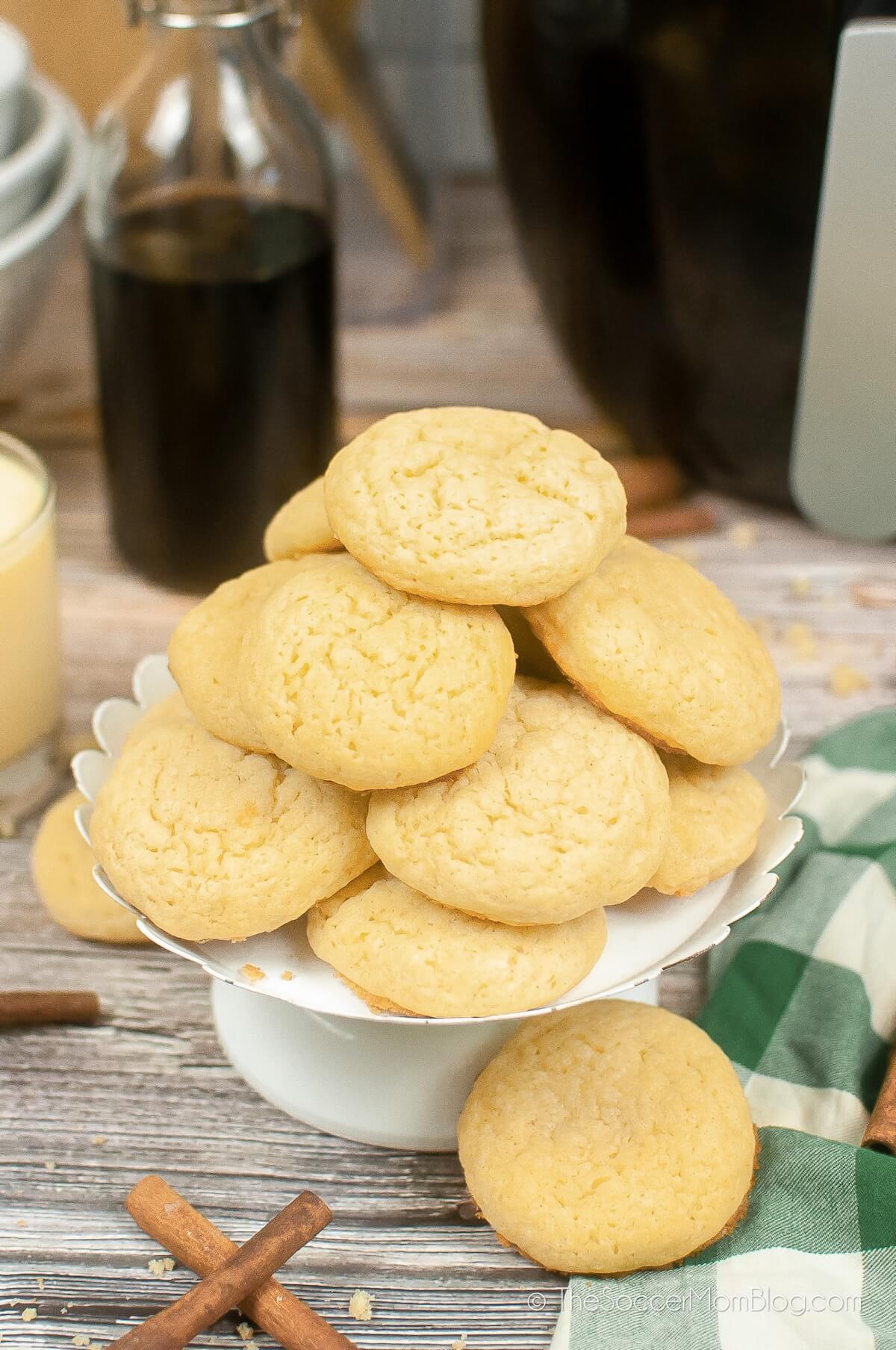 cake stand filled with fluffy yellow eggnog cookies