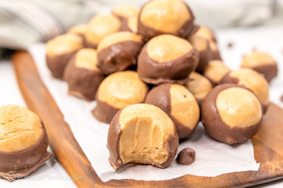 chocolate peanut butter buckeye candy, one with a bite missing.