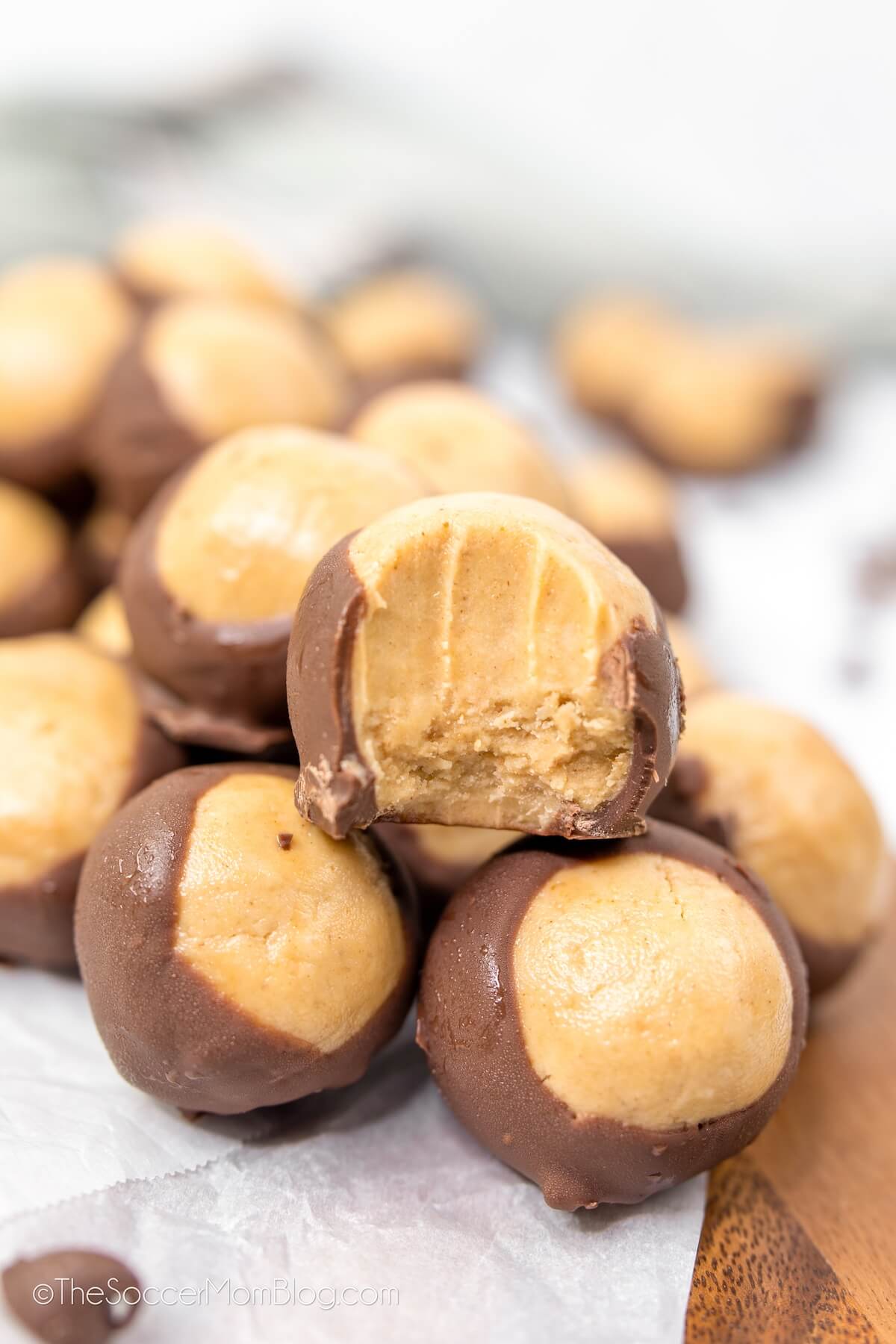 peanut butter balls coated halfway in chocolate.