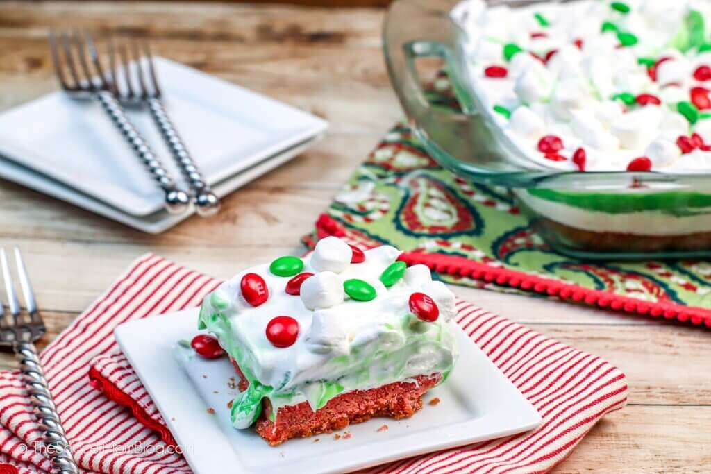 A plate of Christmas Lasagna next to the full baking dish