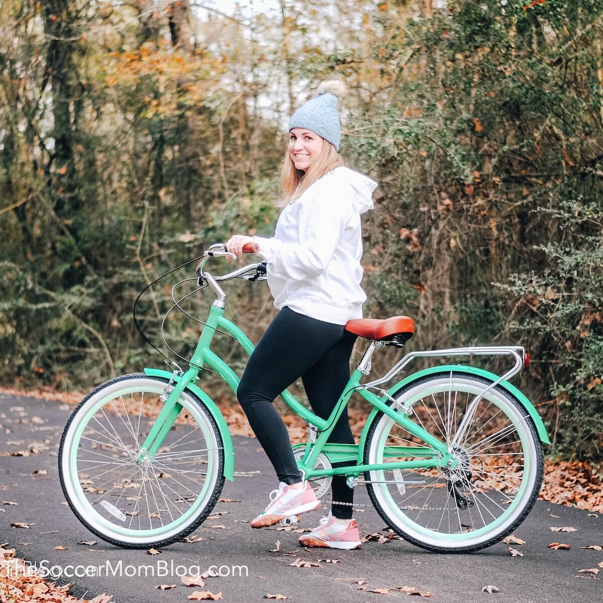woman with mint green cruiser bicycle