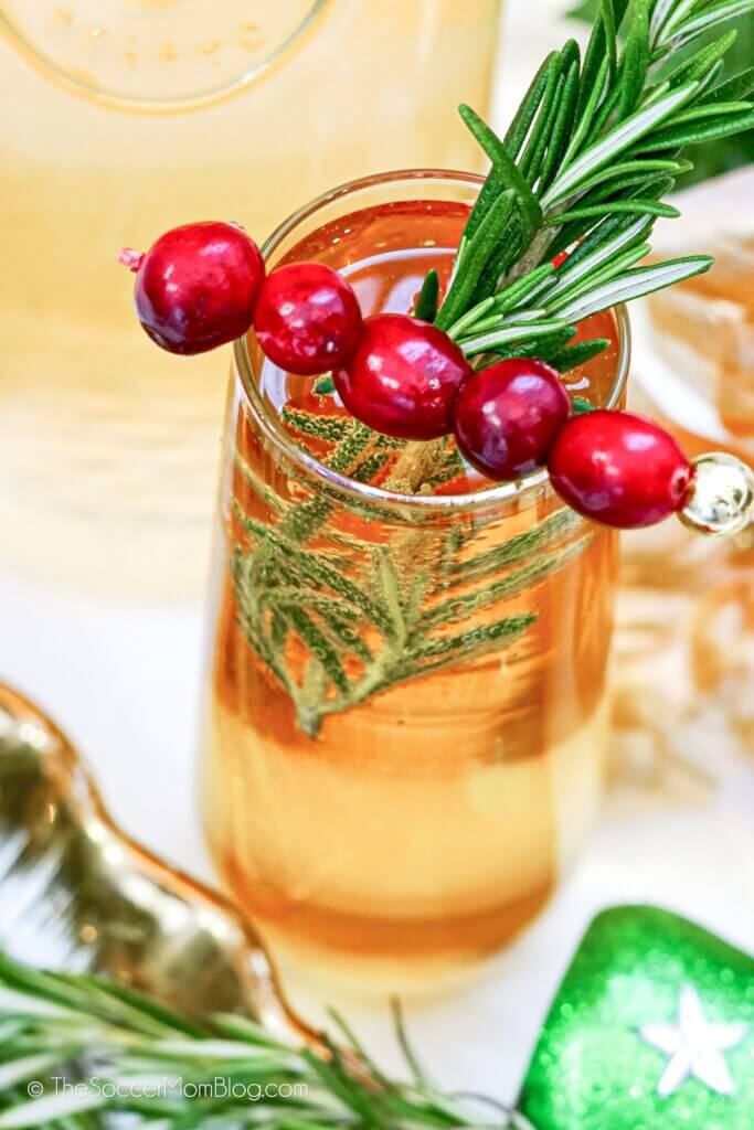 Christmas mimosa made with white cranberry juice, with rosemary sprig