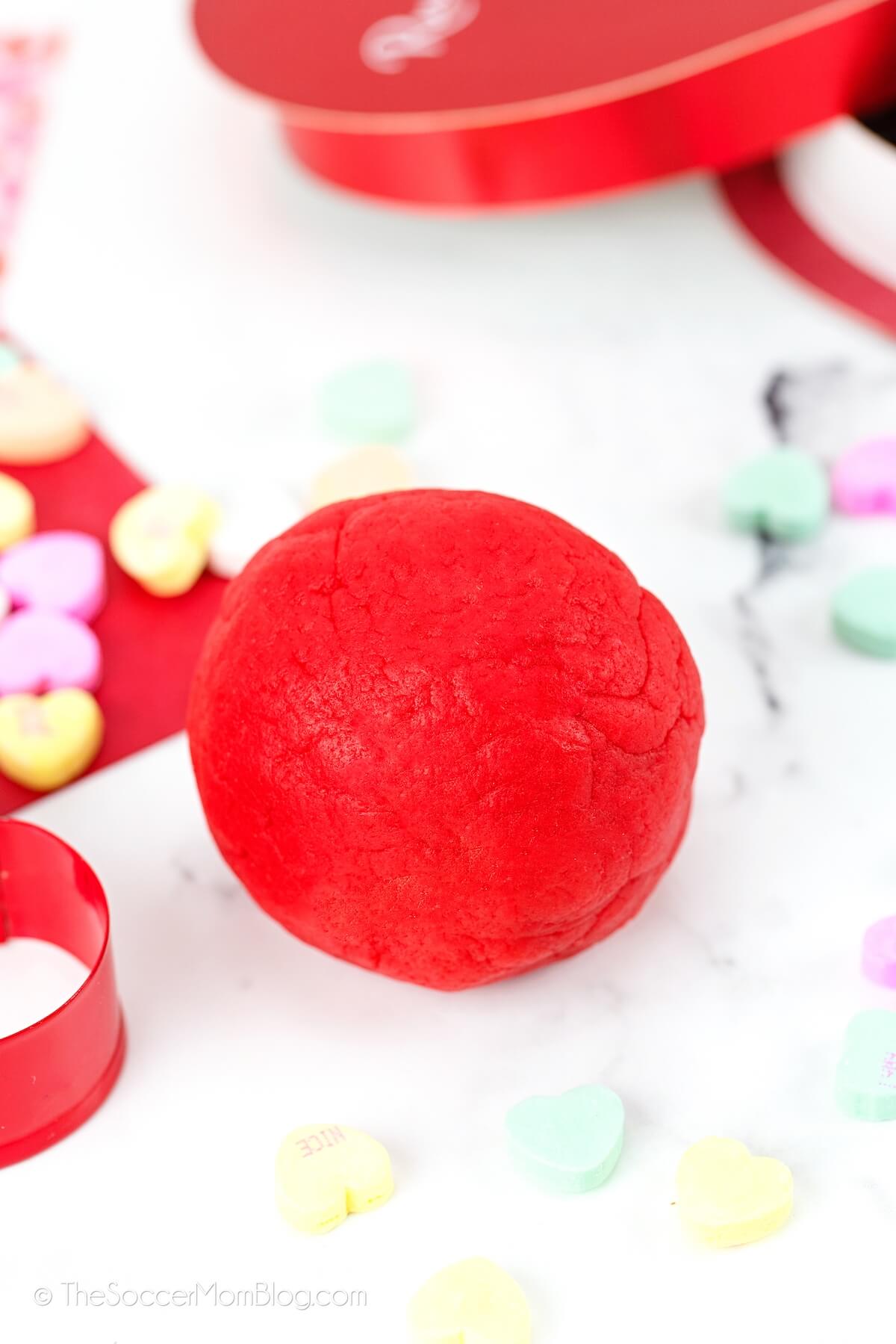 ball of red playdough surrounded by conversation heart candy