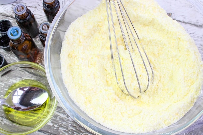 mixing essential oils with baking soda in glass bowl