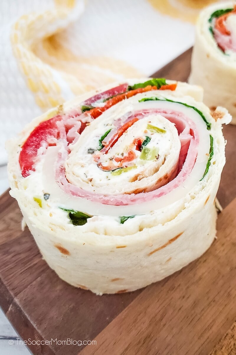 Close up of an Italian Pinwheel appetizer made with tortilla, meat, and cheese