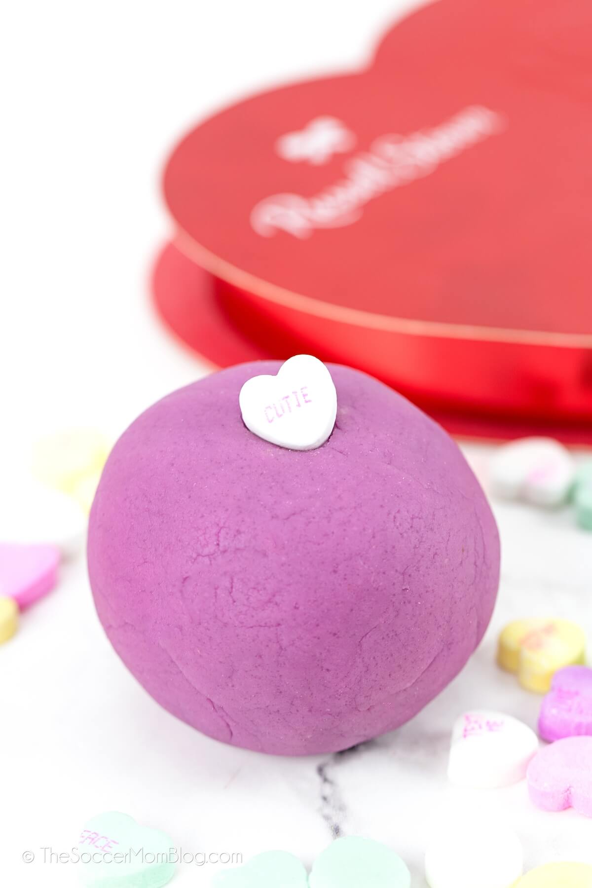 Purple ball of playdough with heart on top