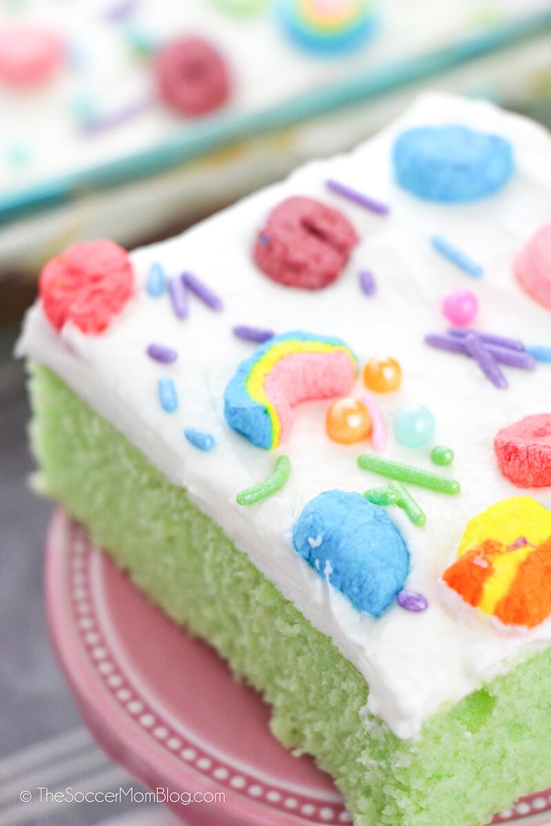 close up on a slice of green sheet cake with Lucky Charms frosting