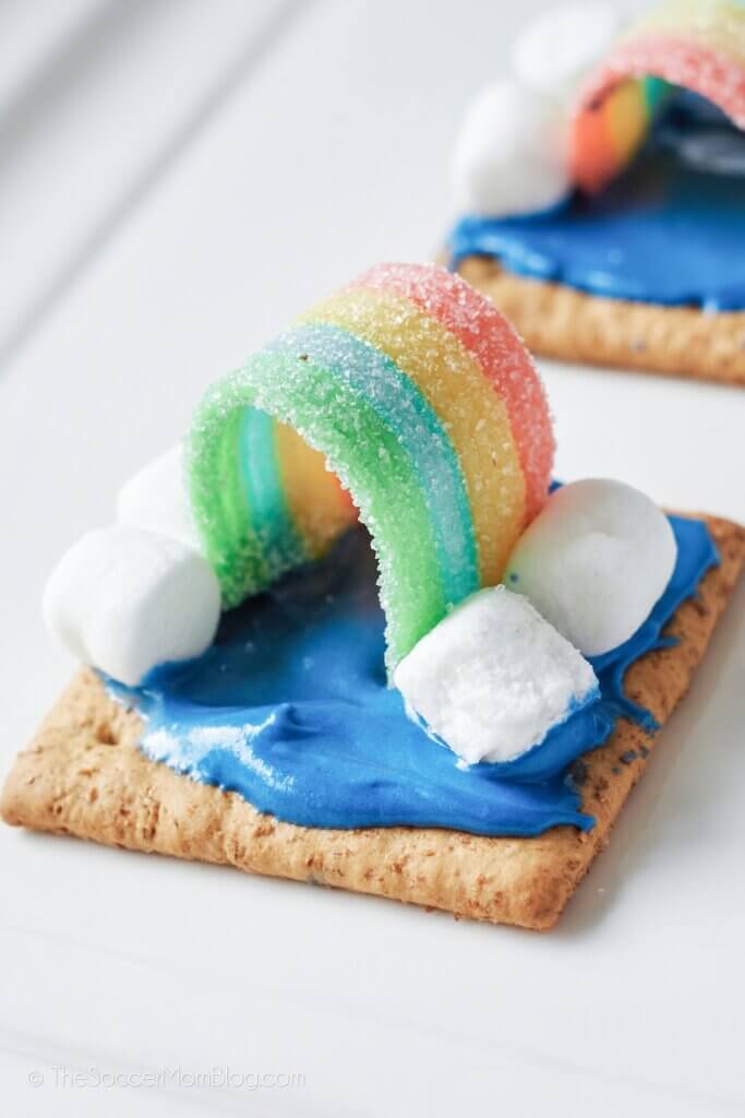 frosted graham crackers decorated to look like a sky with a rainbow